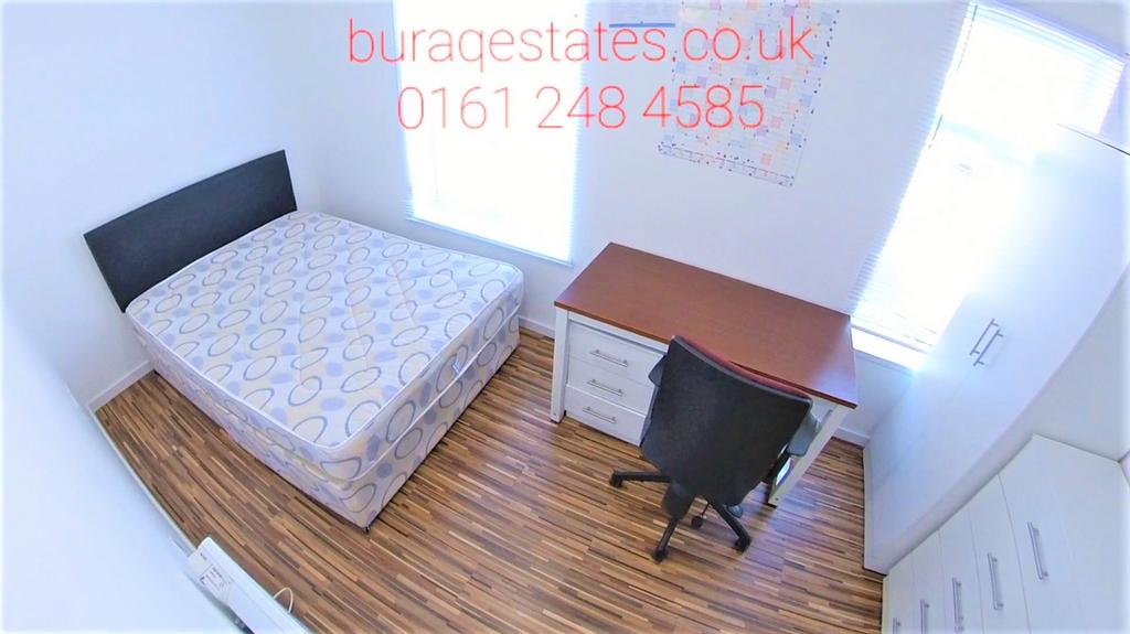 Bright, simply furnished bedroom with a double ...