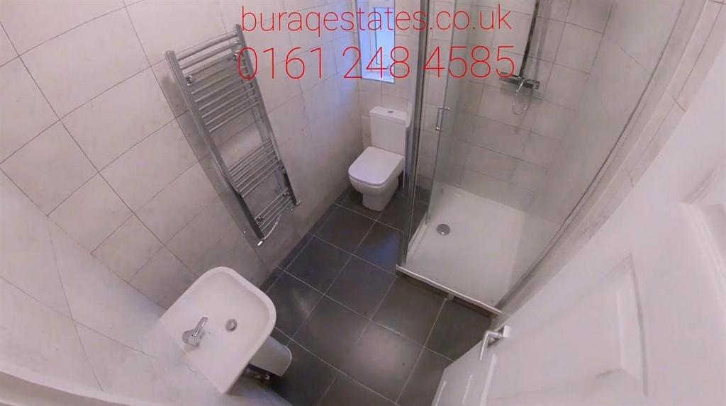 Compact, modern bathroom with tiled walls and f...
