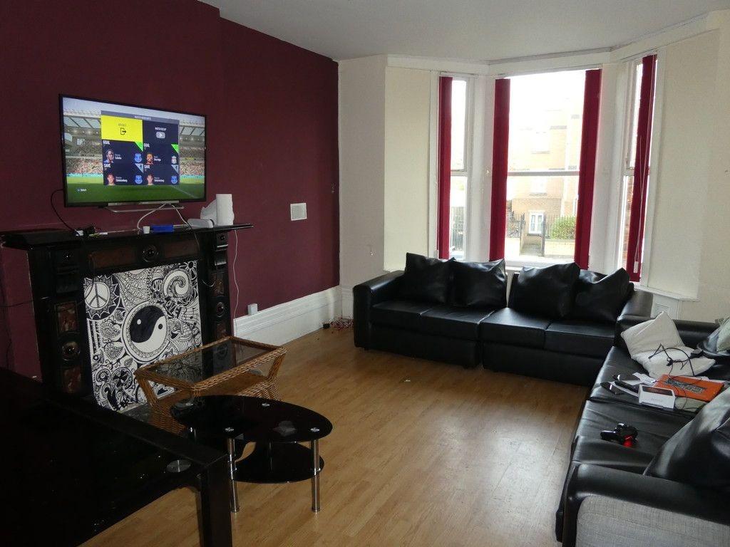 Contemporary living room with a feature firepla...