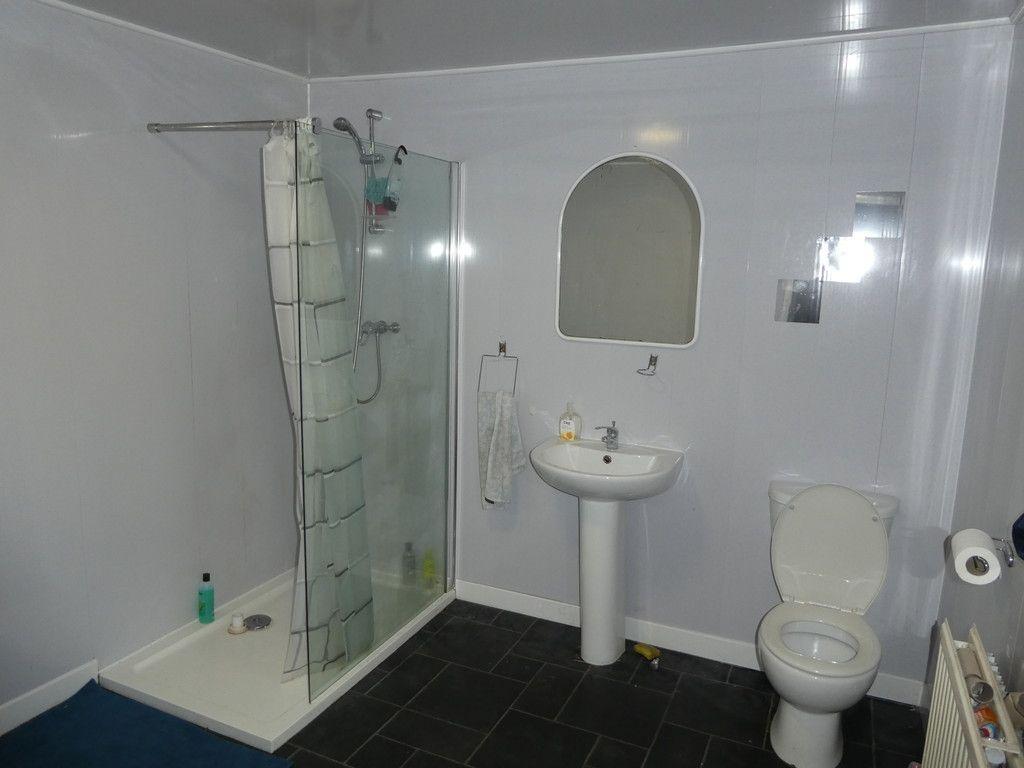 Bright, modern bathroom with a walk-in shower, ...