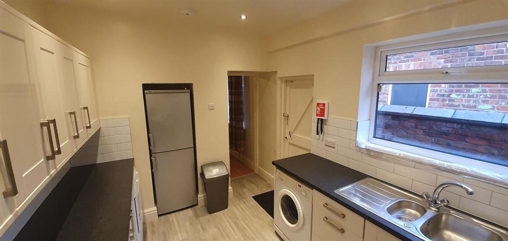 Bright, modern galley kitchen with plenty of st...