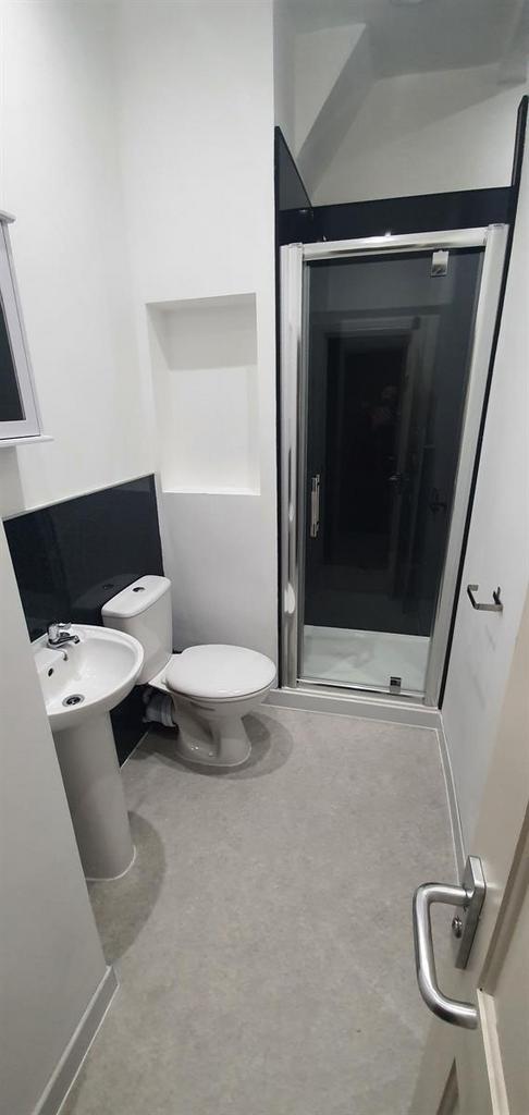 Clean, modern bathroom with a walk-in shower, p...