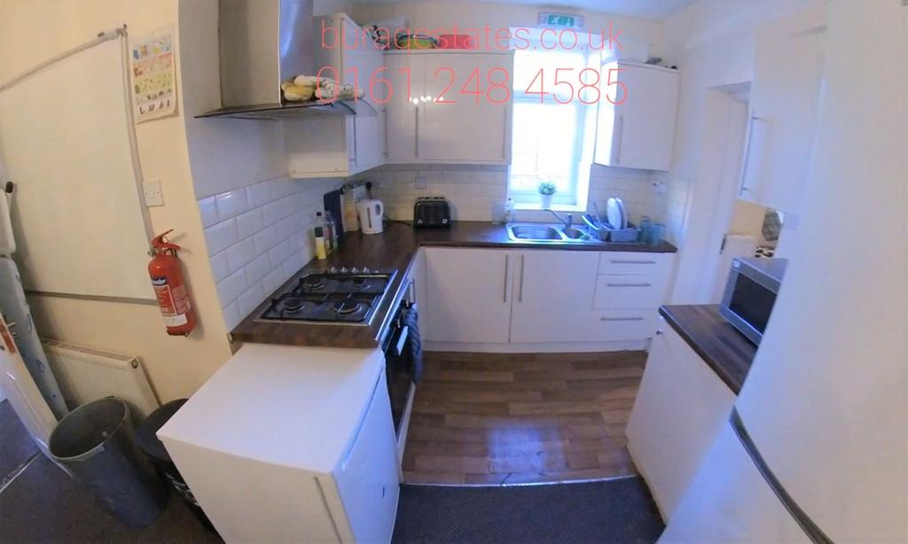 Bright, modern galley-style kitchen with white ...