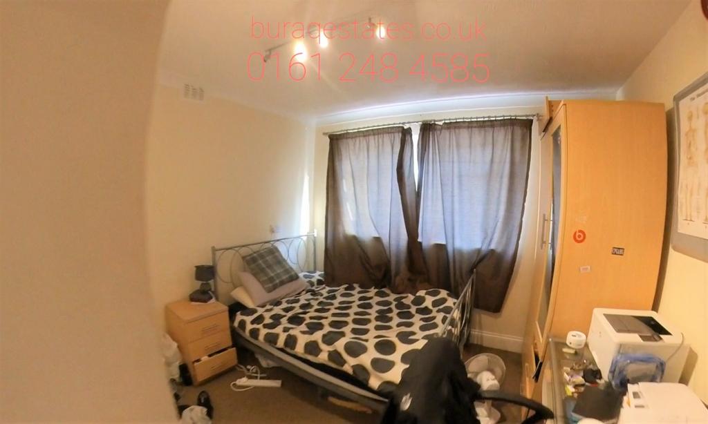 Cozy bedroom with a patterned double bed, soft ...