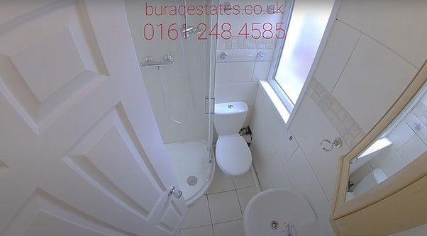 Bright, clean bathroom with tiled floor, a mode...