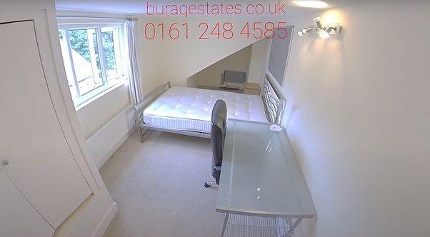 Bright, simply furnished bedroom with a large w...