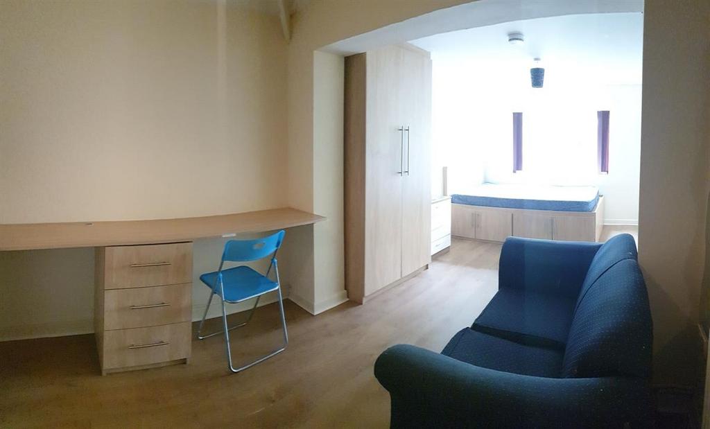 Bright, modern living area with wood-effect flo...