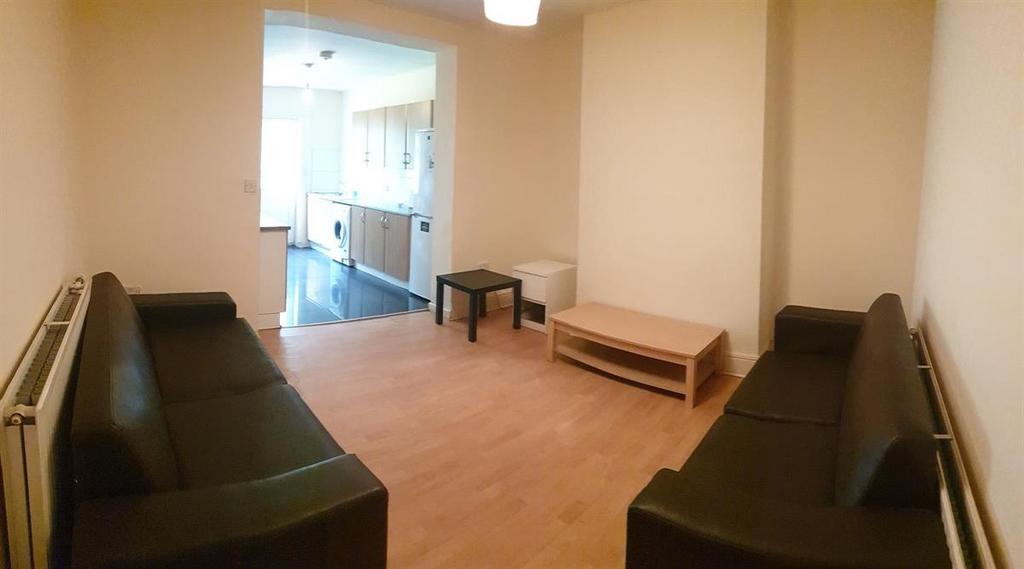 Long living room with matching sofas, light woo...