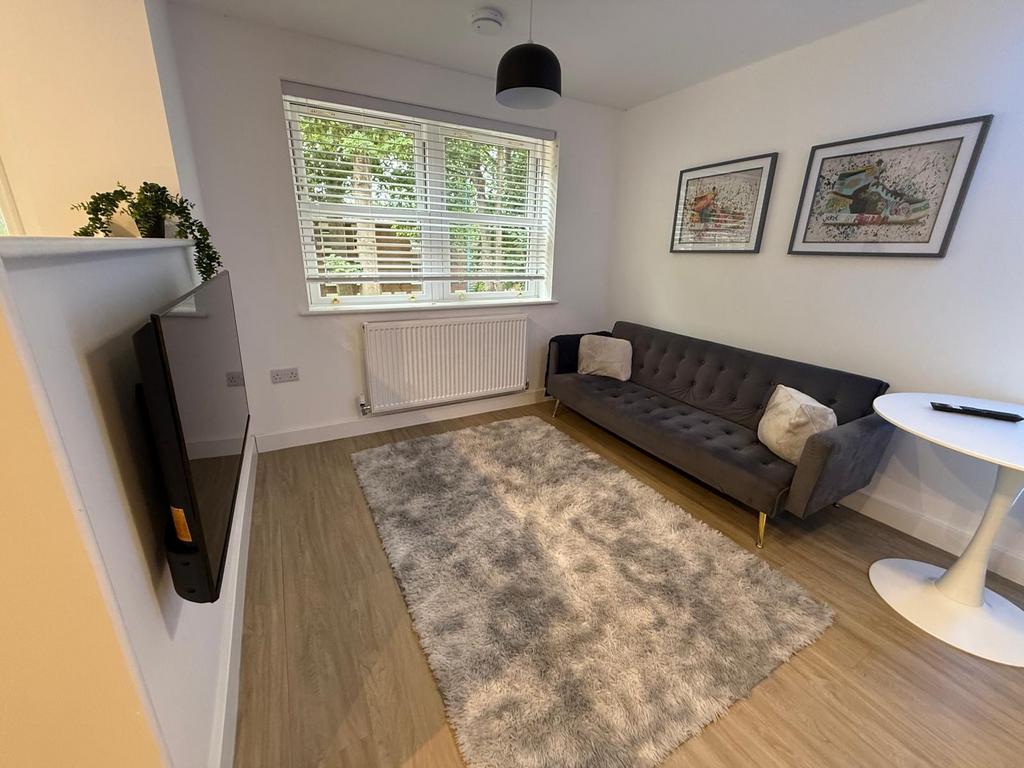 Bright, modern living room with a large window ...