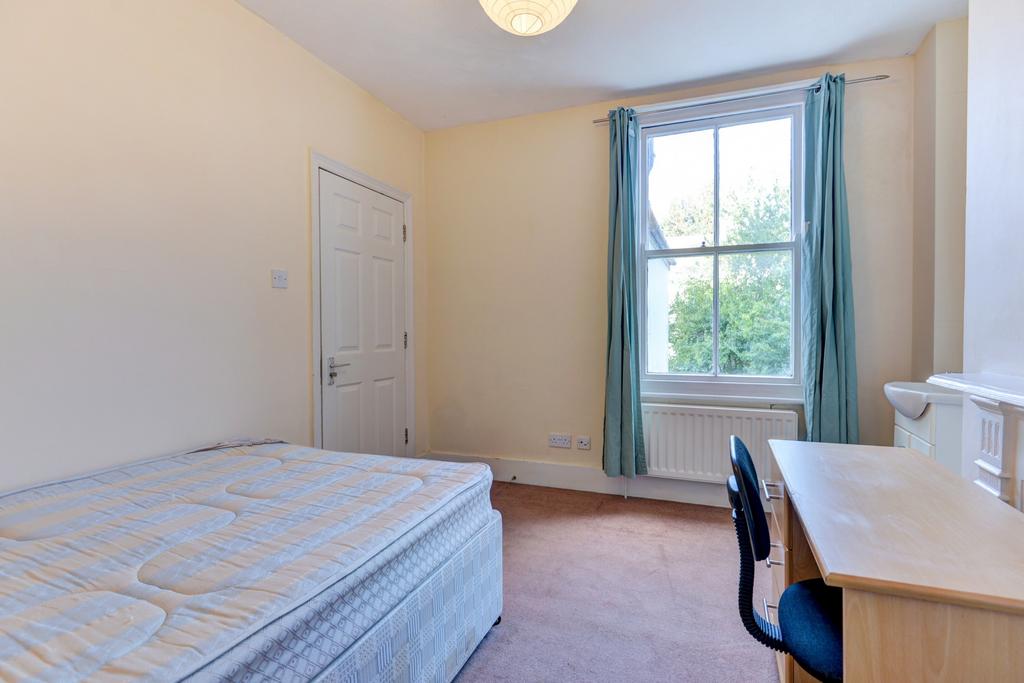 Bright furnished bedroom with a double bed, stu...