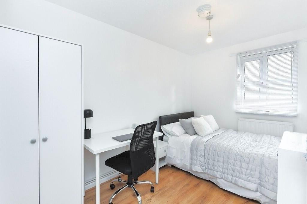 Bright, neatly presented bedroom with a comfort...