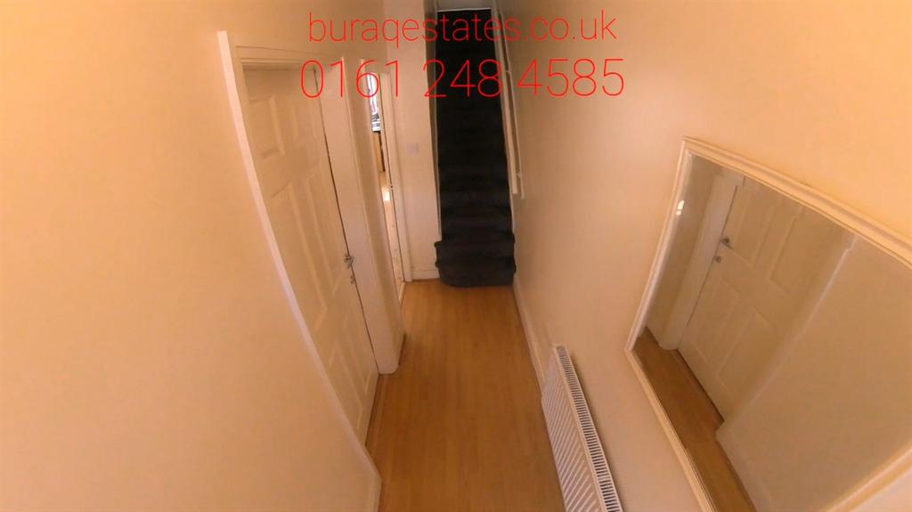 Bright, neutrally painted hallway with wood-eff...