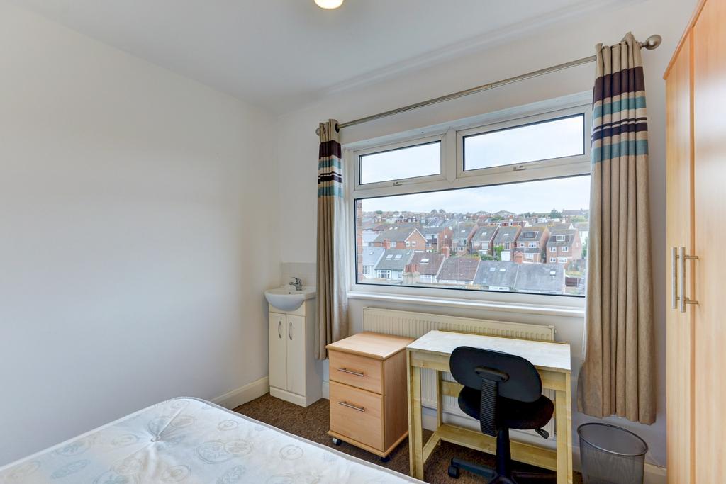 Bright single bedroom with a large window overl...