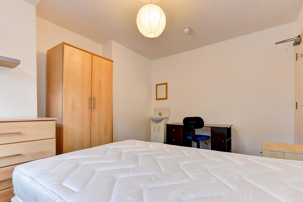 Bright, tidy double bedroom featuring a comfort...