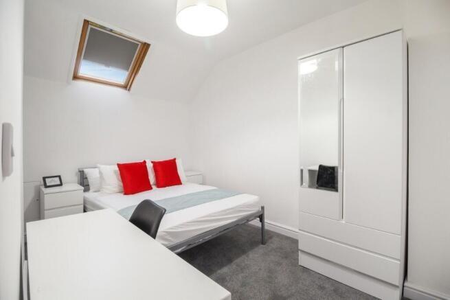 A bright and modern bedroom featuring a double ...