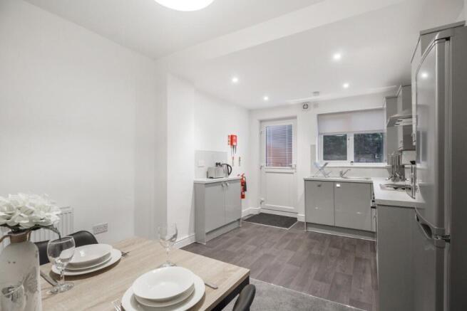 A bright and modern kitchen with ample natural ...