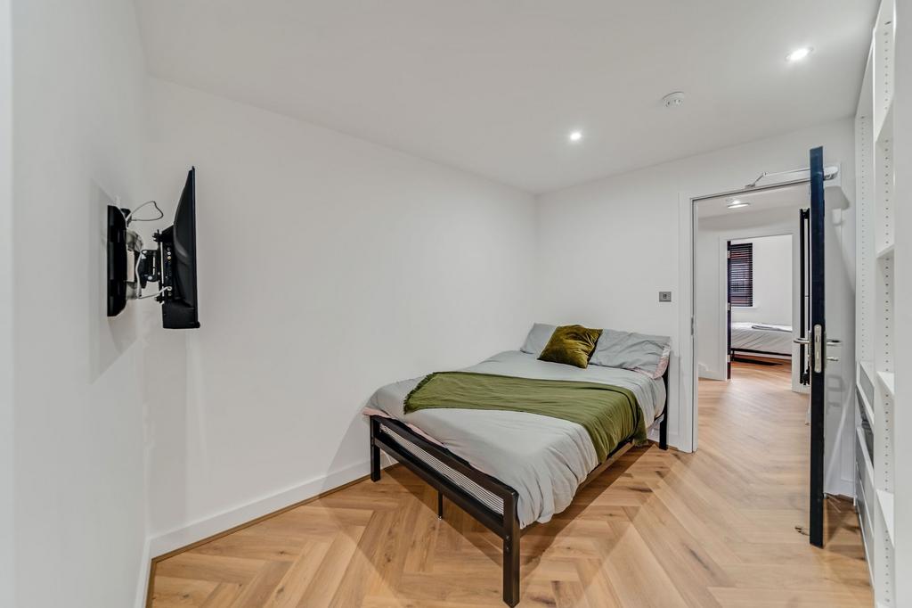 A tidy and modern bedroom featuring a comfortab...