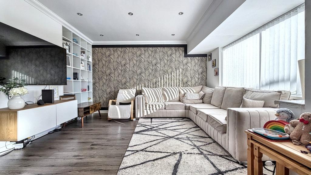 Bright, contemporary living room with a large L...