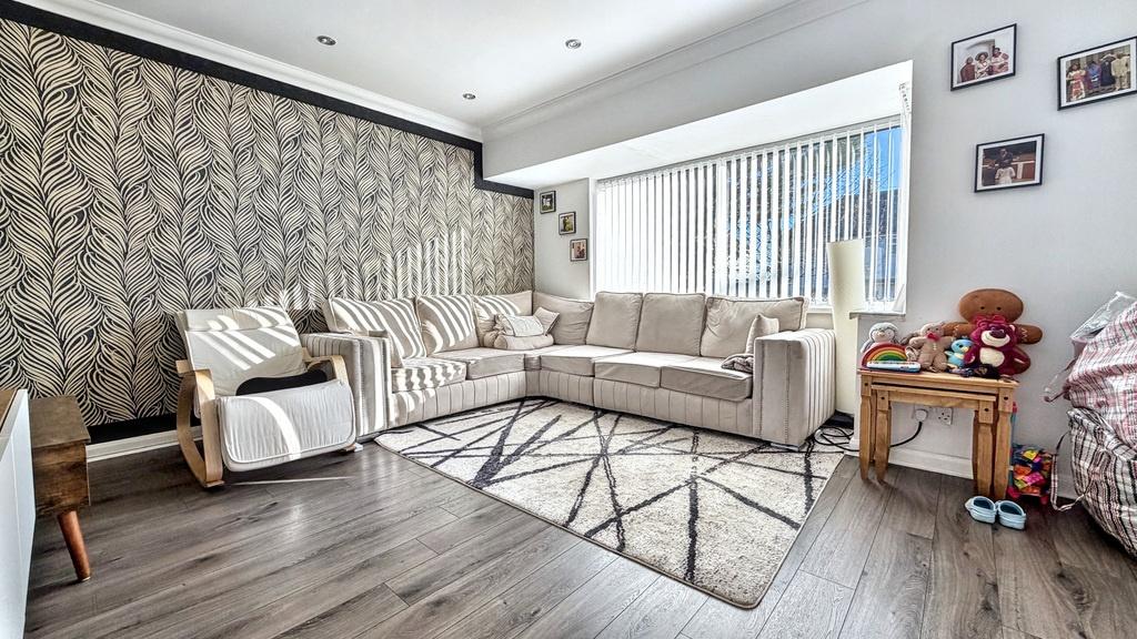 Bright, stylish living room with a large L-shap...