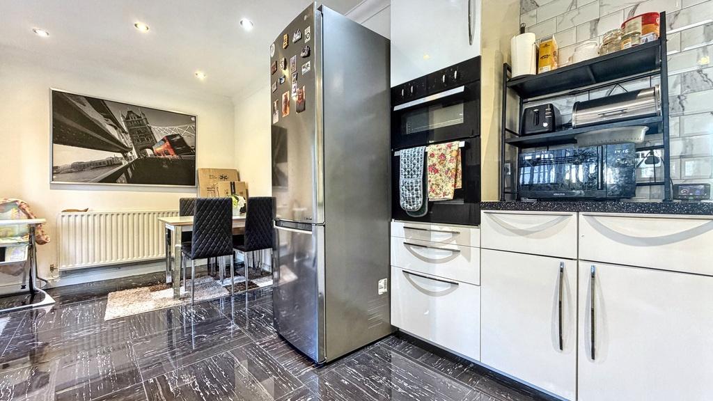 Modern kitchen with glossy floor tiles, integra...