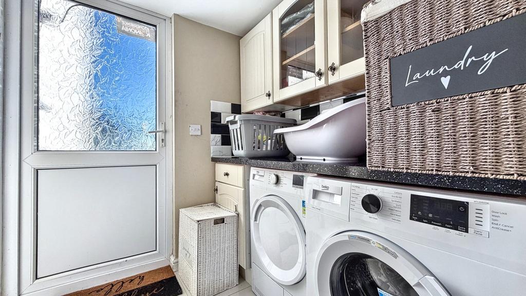 Bright, well-equipped laundry room with front‑l...