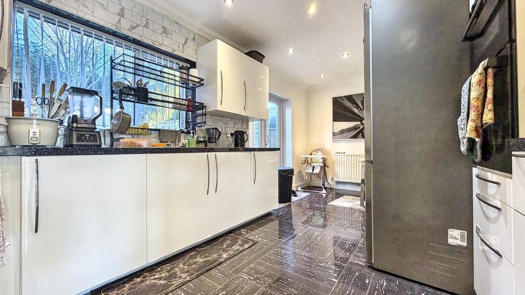 Stylish modern galley kitchen with sleek white ...