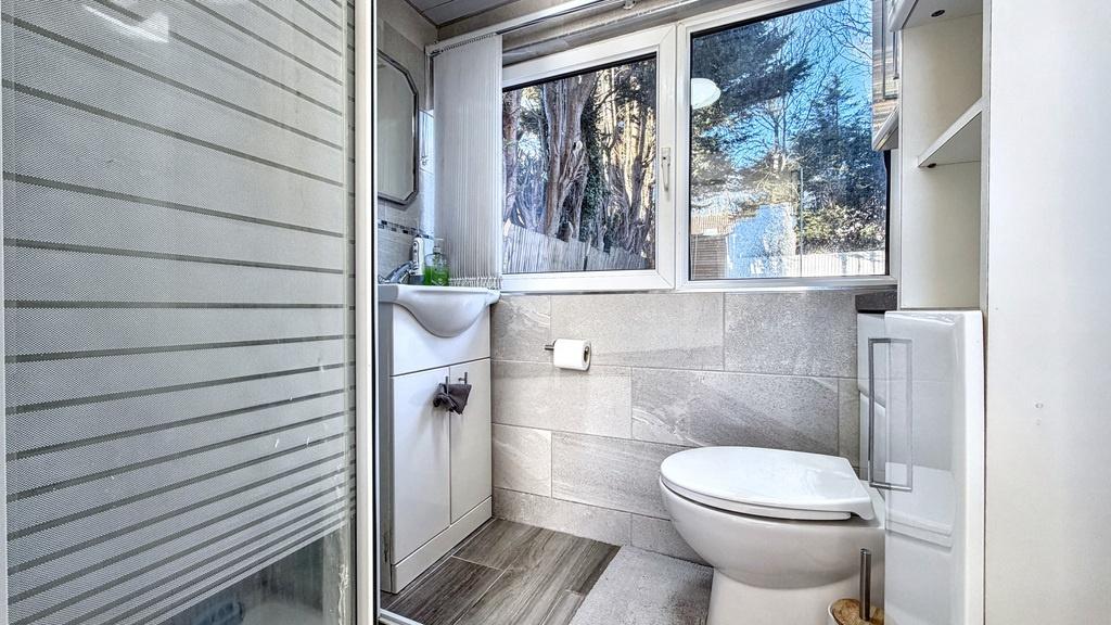 Modern, well-kept bathroom with a bright froste...