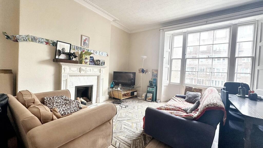 Bright, comfortable living room with a large wi...