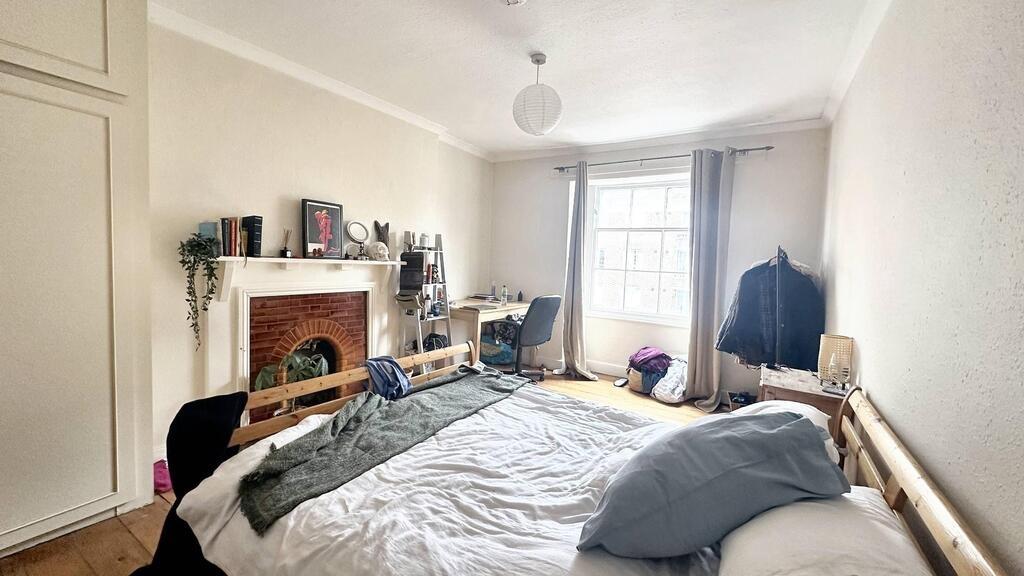 Bright, well-presented bedroom with a large win...