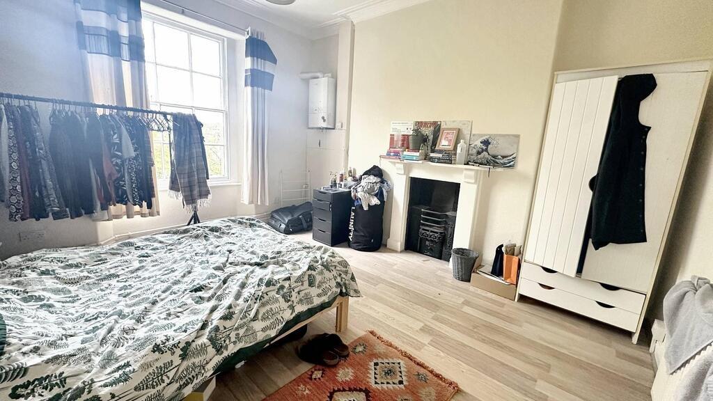 Bright bedroom with a double bed, large window ...