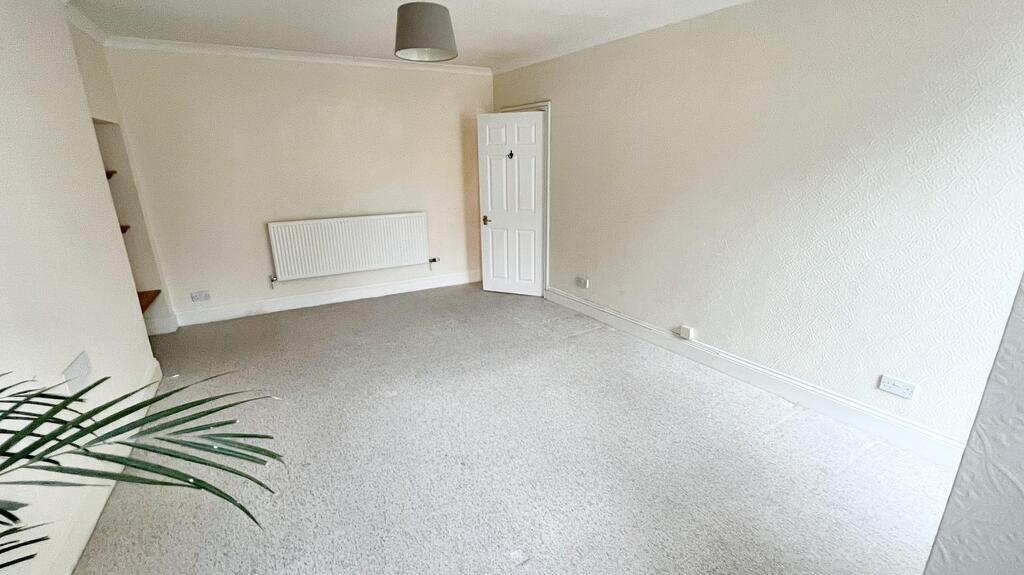 Bright, neutral living room with light carpet, ...