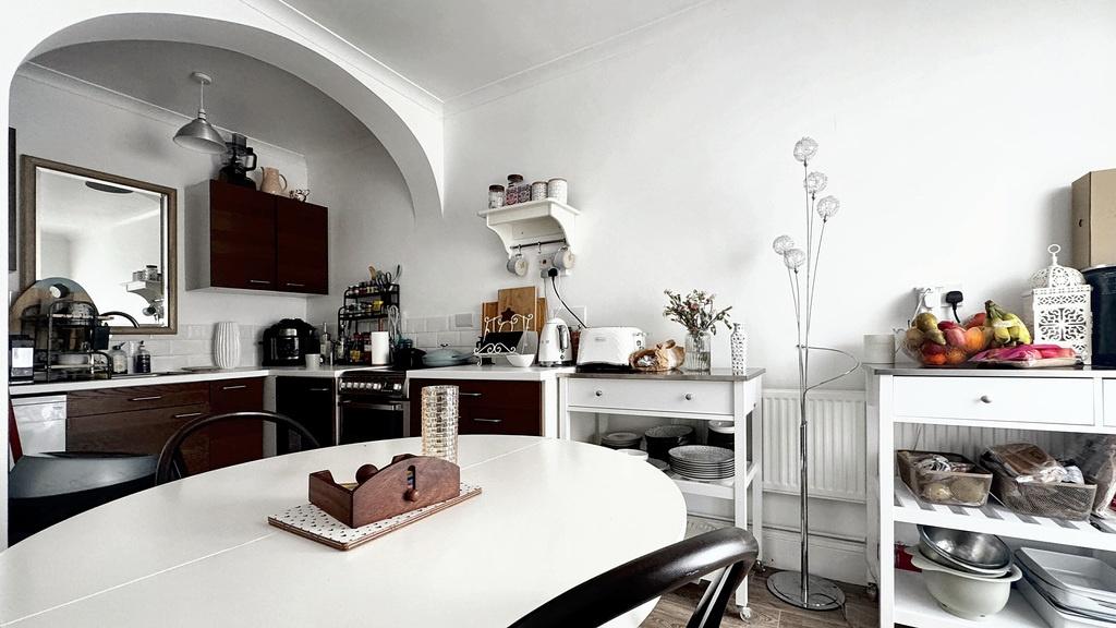 Bright, modern kitchen with a clean white dinin...