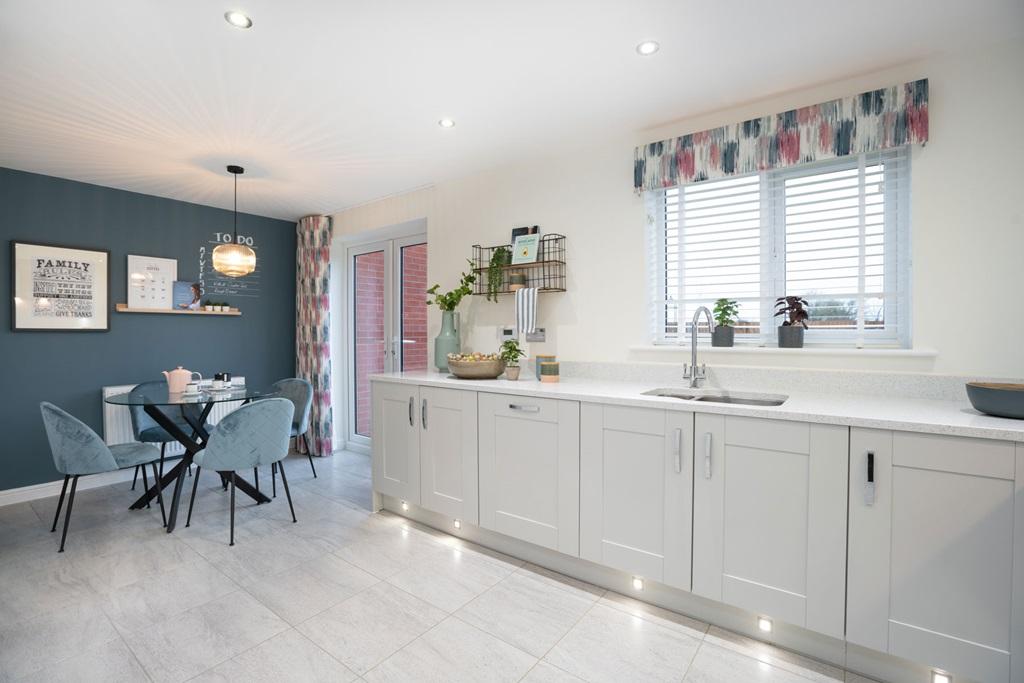 Sociable kitchen with breakfast area and doors...