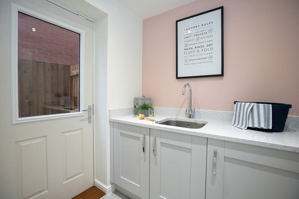 The washing machine has it's own utility room