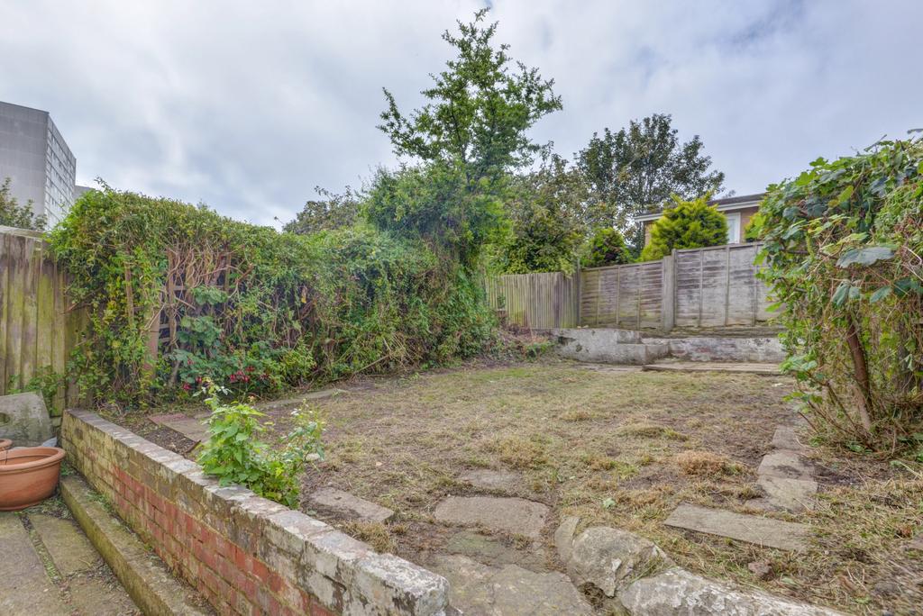 Private rear garden with a paved seating area, ...