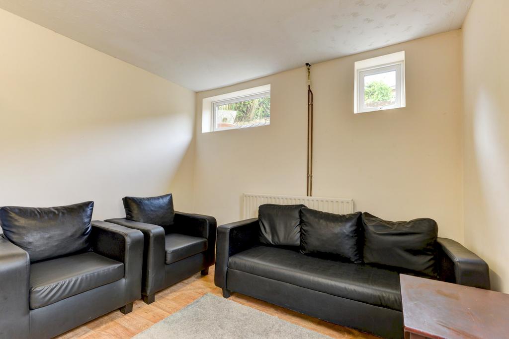 Bright communal lounge with comfortable black l...