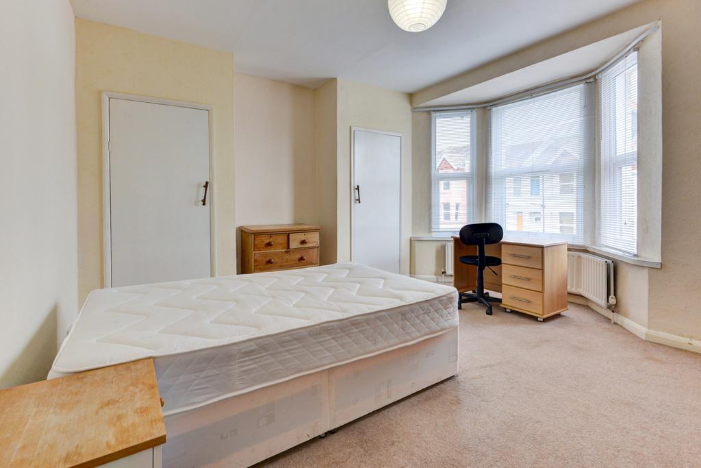 Bright and spacious master bedroom featuring a ...