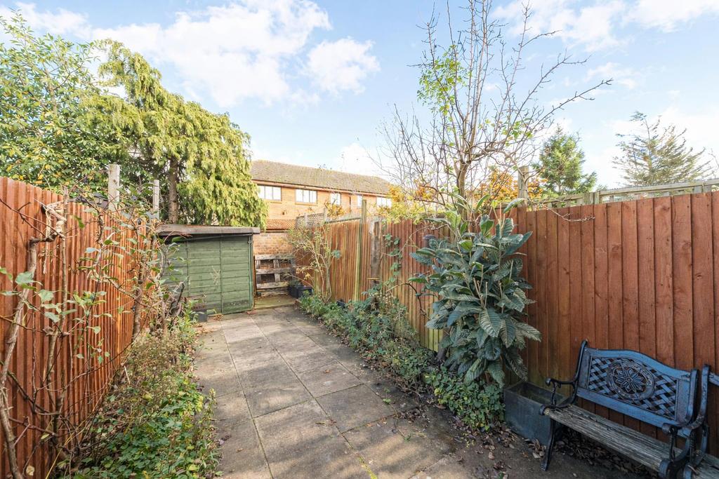 Sunny garden path with green shed.png