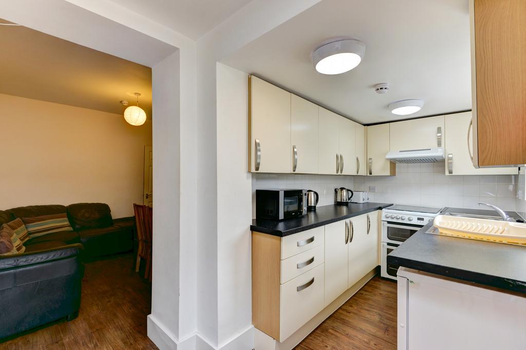 Bright modern kitchen with light cabinetry, int...