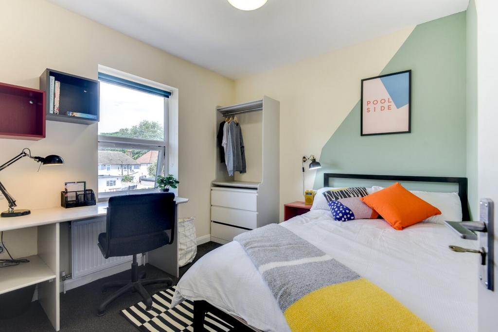 Bright, well-appointed bedroom with a comfortab...