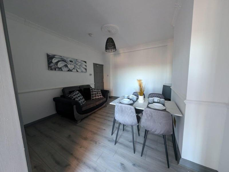 Bright, modern living and dining area with cont...