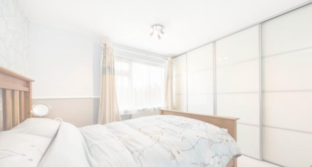 A bright and tidy double bedroom featuring ampl...