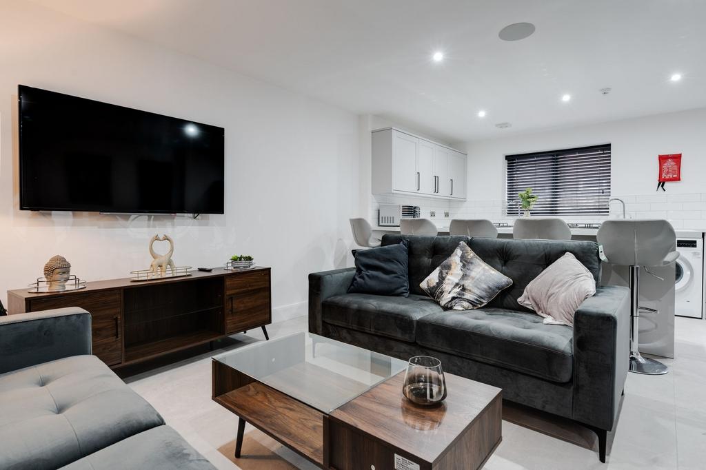 Modern and spacious living room featuring a lar...
