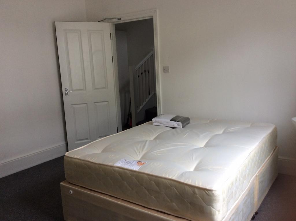 Bright, simply furnished bedroom with a clean d...
