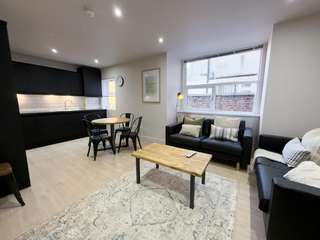 Bright, modern open-plan living area with a com...