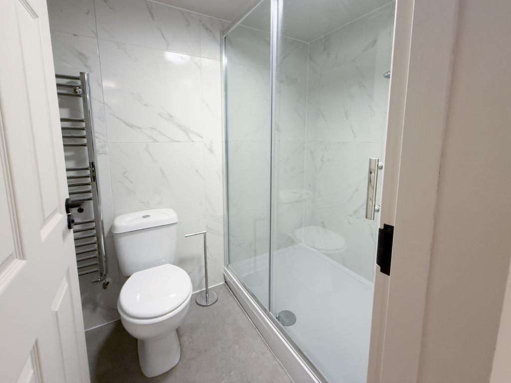 Bright, modern bathroom with a walk-in shower, ...