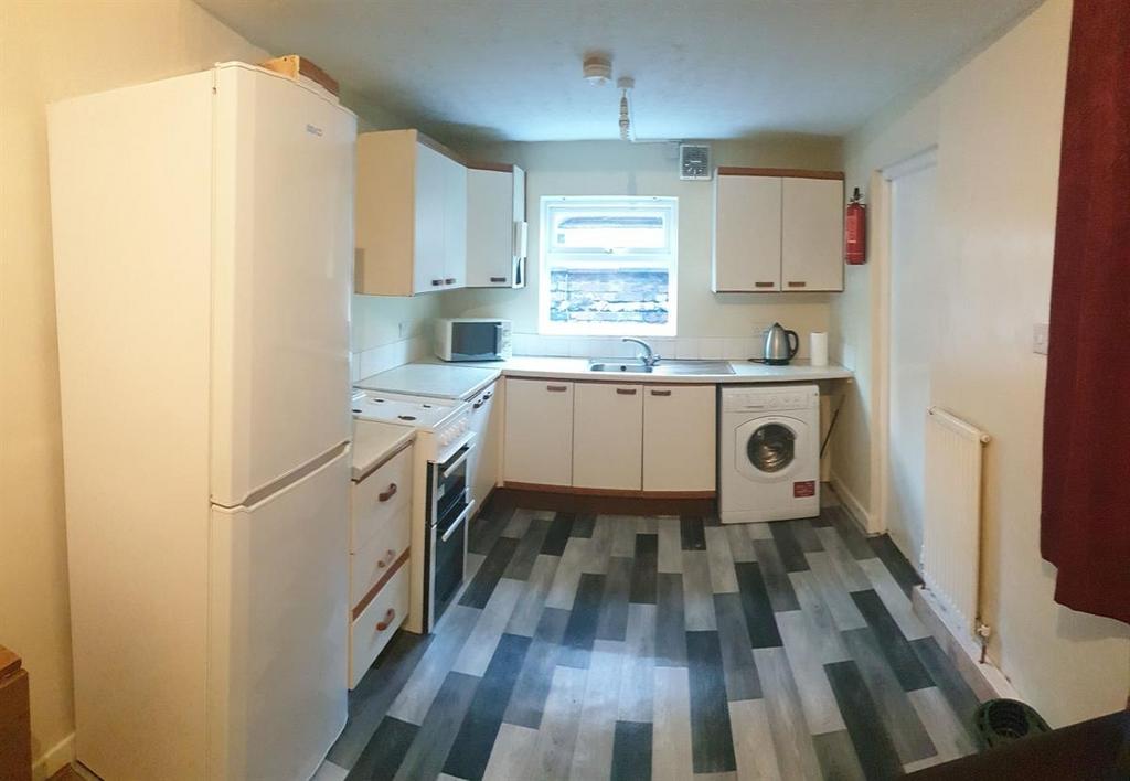 Bright fitted kitchen with ample storage, frees...