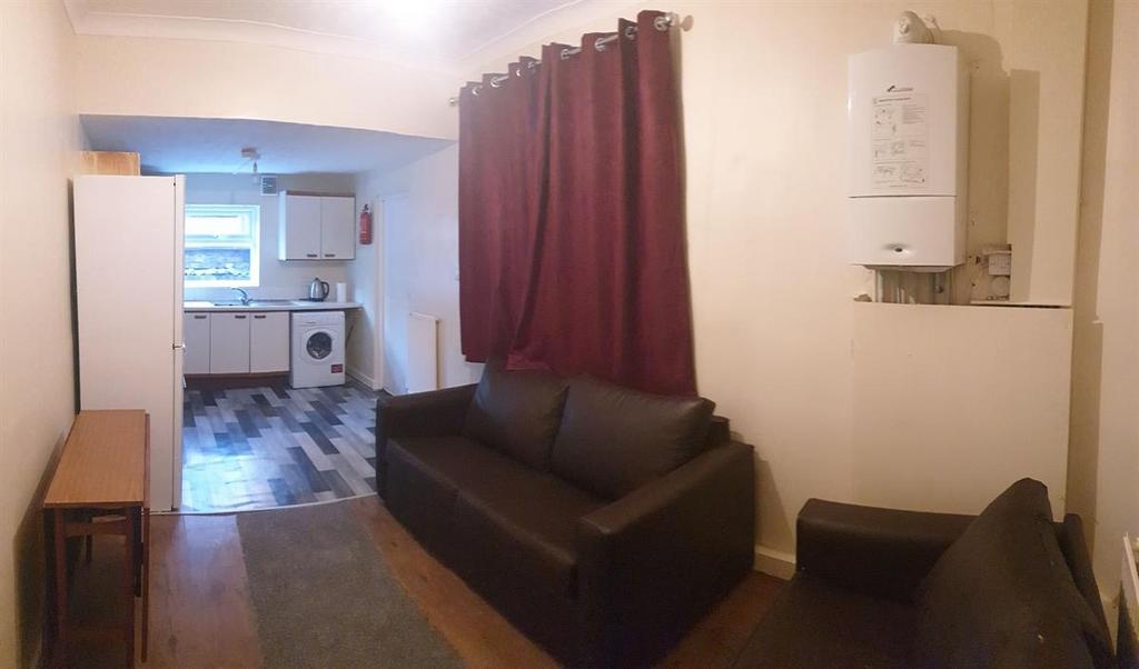 Comfortable lounge area with two dark sofas, a ...