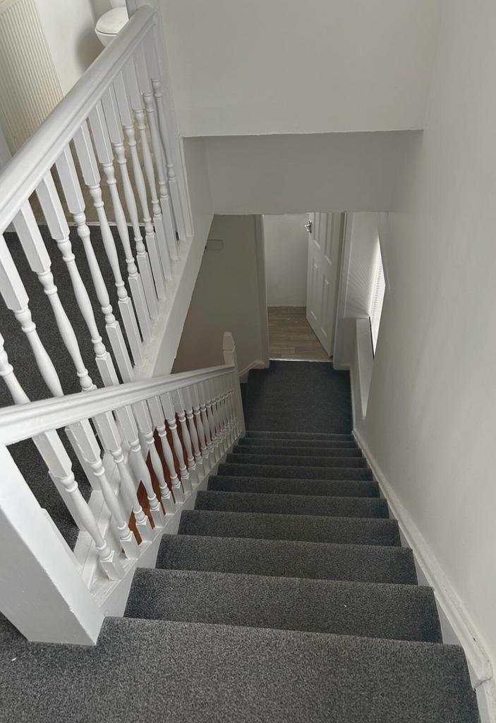 Bright, freshly painted staircase with new grey...