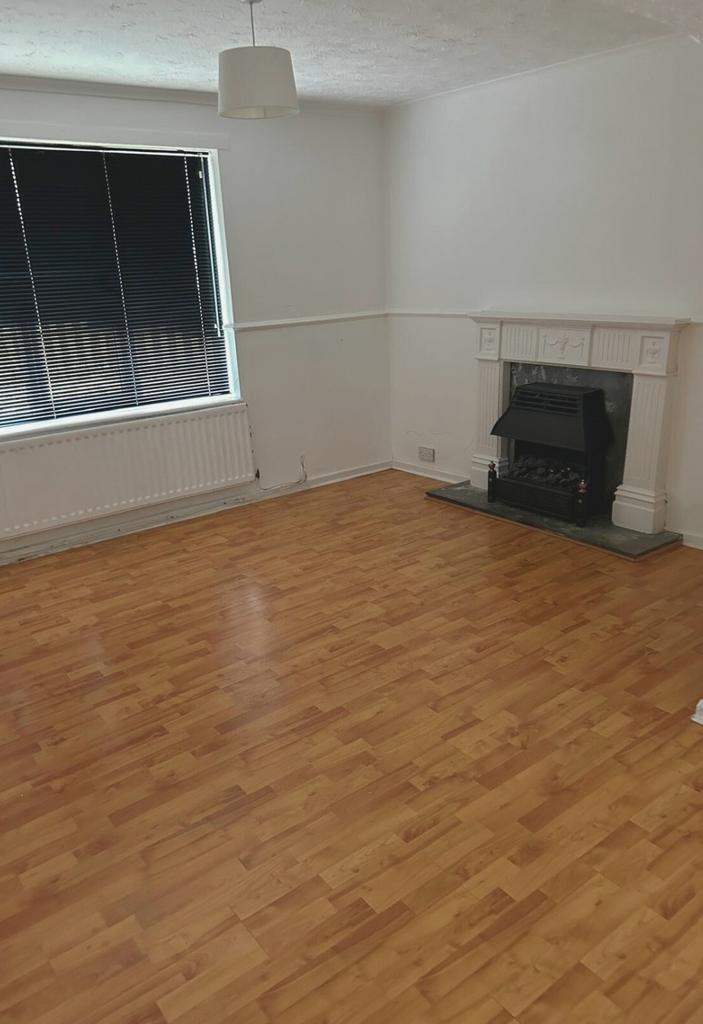 Bright, freshly painted living room with warm l...